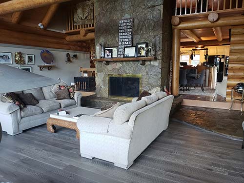 Floors in stalled in a living room in a log cabin home – Pekoe Oak Hardwood