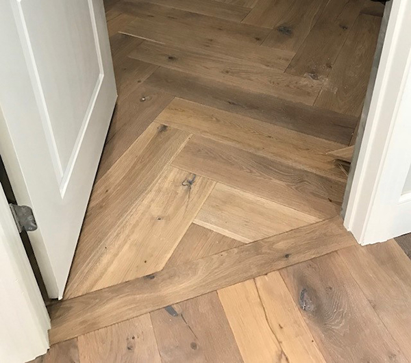 Hallmark Floors herringbone doorway install by Greer Flooring Center